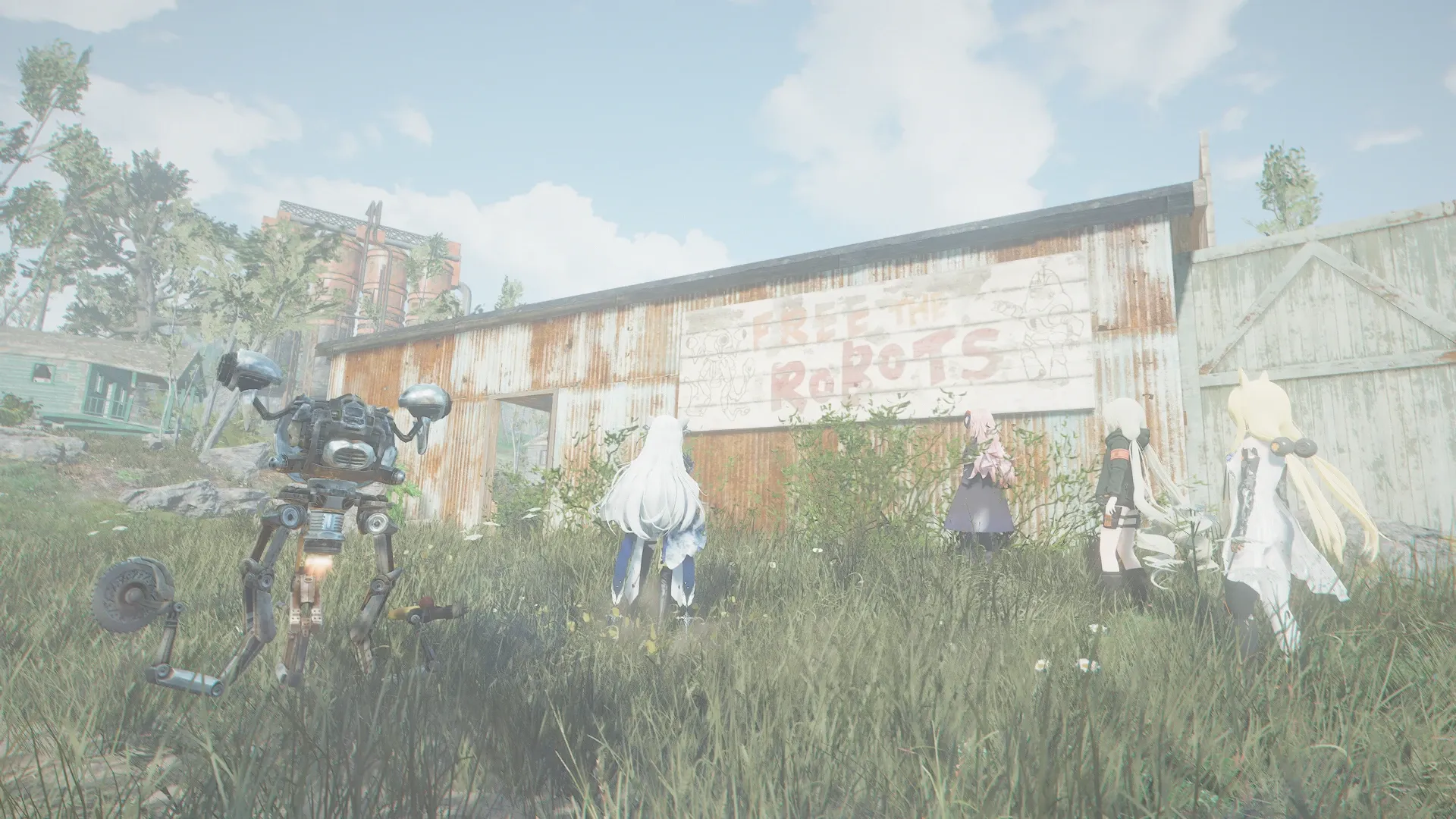 写真: FREE THE ROBOTSと書かれた看板が納屋に建てられている。